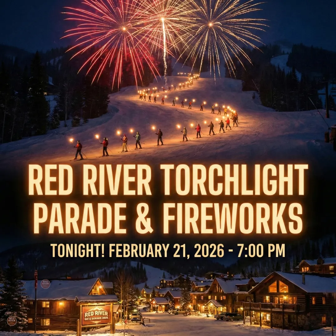 A promotional graphic for the Red River Torchlight Parade & Fireworks. The image features a night scene of a snowy ski mountain with a line of skiers holding bright torches winding down the slope, capped by large red and gold fireworks in the sky. Below, a snowy village glows with warm window lights. Large text overlays the image reading: "RED RIVER TORCHLIGHT PARADE & FIREWORKS" followed by the date and time: "TONIGHT! FEBRUARY 21, 2026 - 7:00 PM.